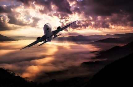 Airplane in flight in sunset