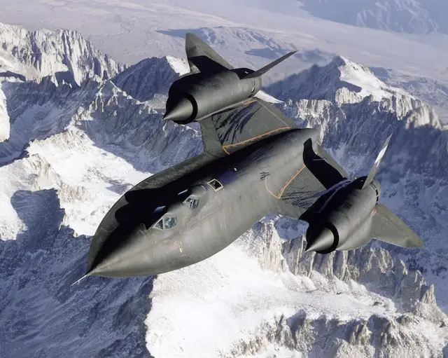 Lockheed SR-71 Blackbird in flight over snowy mountains